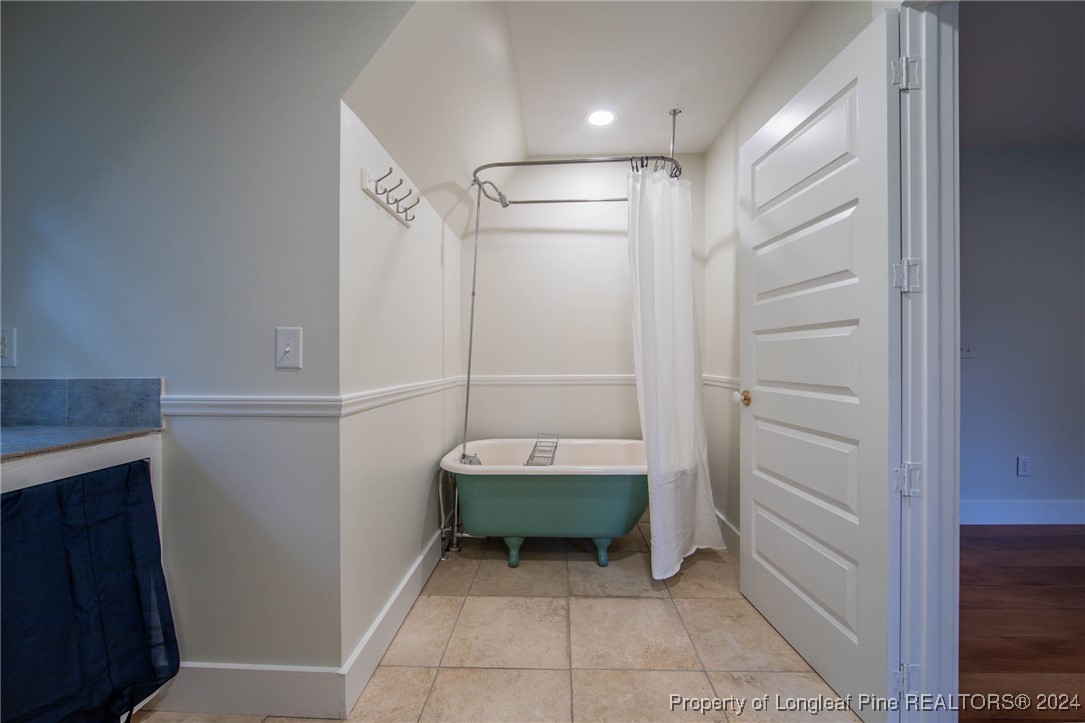 222 Goodwill Road Southern Pines, NC 28387 - Photo 29 of 49 a bathroom with a bathtub and a shower