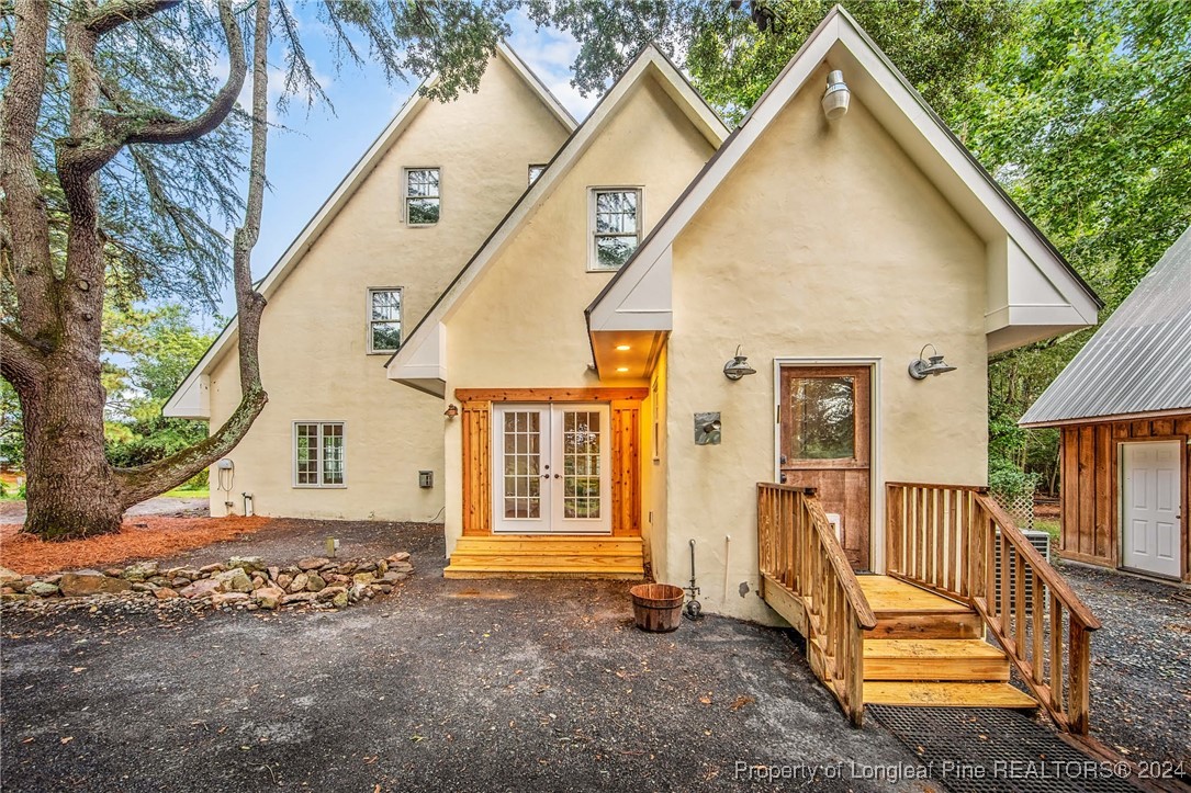 222 Goodwill Road Southern Pines, NC 28387 - Photo 3 of 49 a view of a house with wooden fence