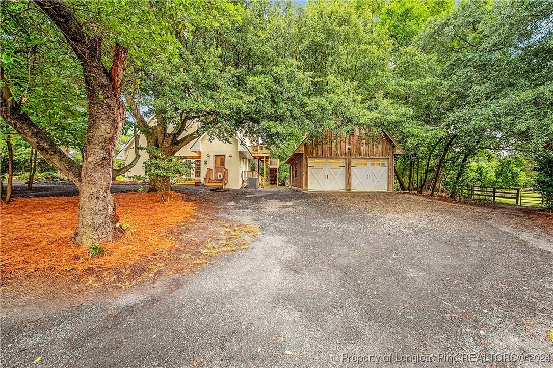 222 Goodwill Road Southern Pines, NC 28387 - Photo 34 of 49 a house with trees in front of it