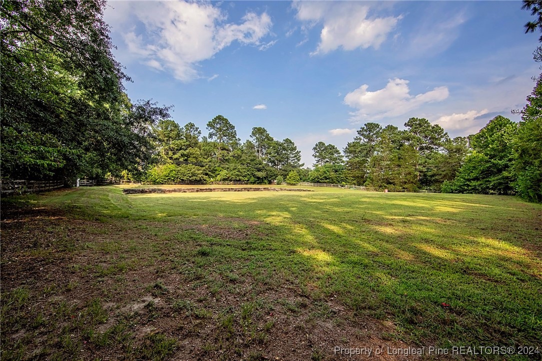 222 Goodwill Road Southern Pines, NC 28387 - Photo 40 of 49 a view of a big yard with swimming pool and green space