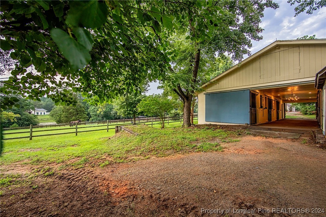 222 Goodwill Road Southern Pines, NC 28387 - Photo 4 of 49 a view of a house with a yard and a garage