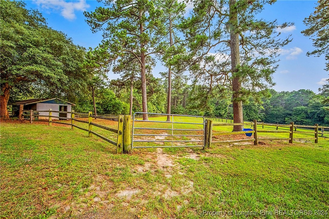 222 Goodwill Road Southern Pines, NC 28387 - Photo 43 of 49 a view of a swimming pool with a bench