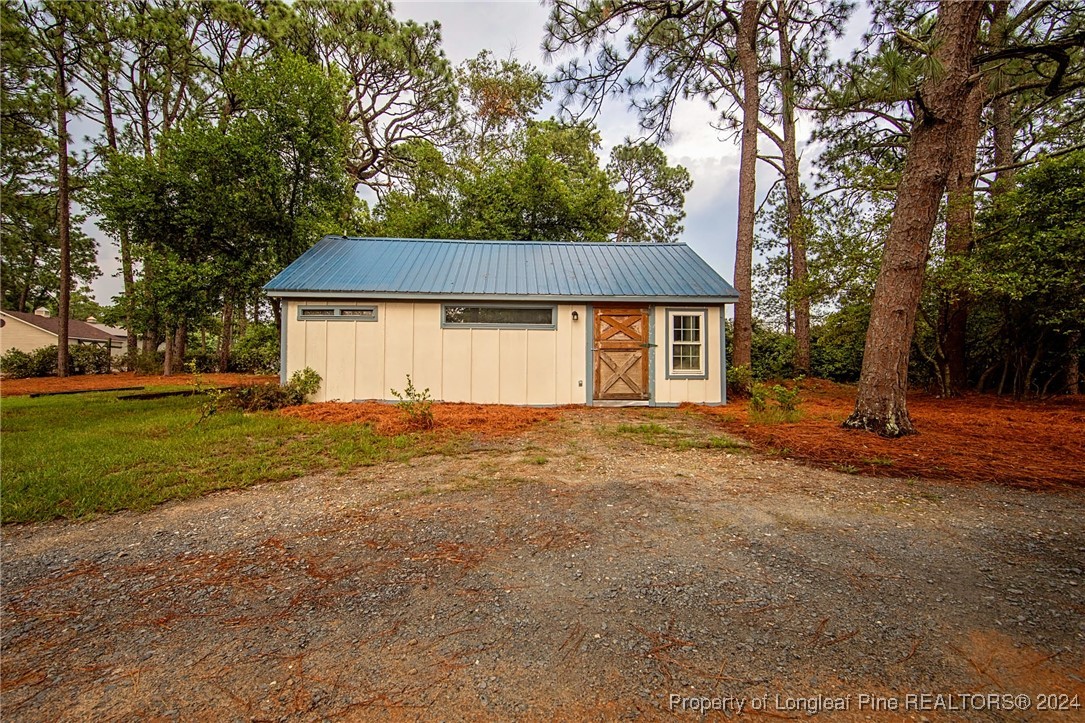 222 Goodwill Road Southern Pines, NC 28387 - Photo 46 of 49 a front view of a house with a garden