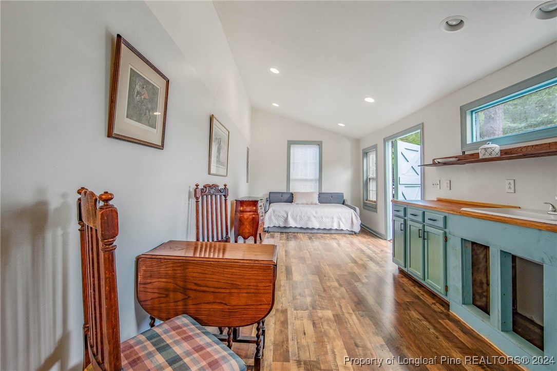 222 Goodwill Road Southern Pines, NC 28387 - Photo 47 of 49 a living room with furniture a flat screen tv and a table