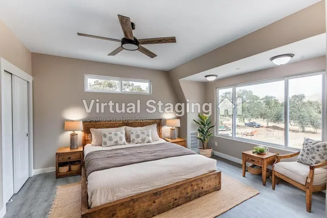 a view of an empty room with wooden floor and a ceiling fan