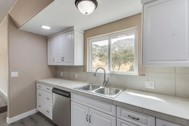 a kitchen with appliances cabinets and a sink