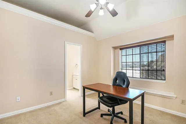 a view of a livingroom with a ceiling fan and window