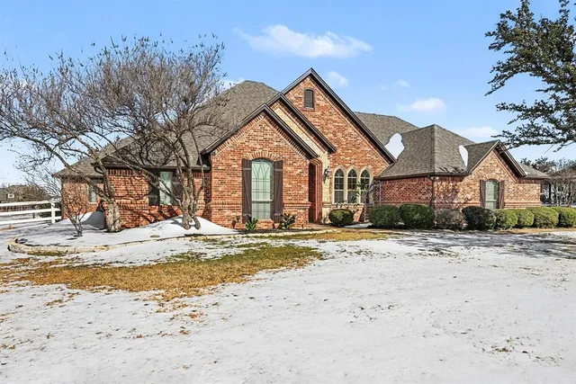 a view of a house with a snow on the road