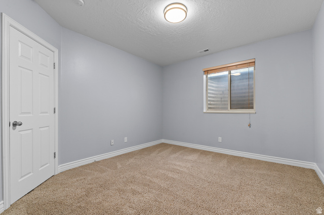 1501 West Elk Circle Mapleton, UT 84664 - Photo 36 of 39 Carpeted room featuring a white paneled door, light gray walls, white baseboards, and a window with wood-finish blinds