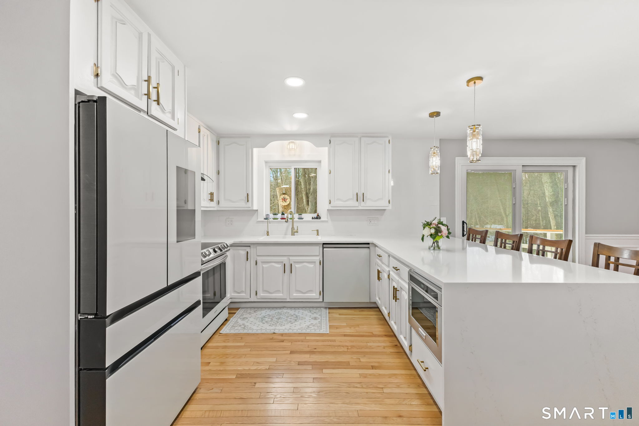 299 Redding Road Redding, CT 06896 - Photo 9 of 40 a large white kitchen with cabinets a sink and stainless steel appliances
