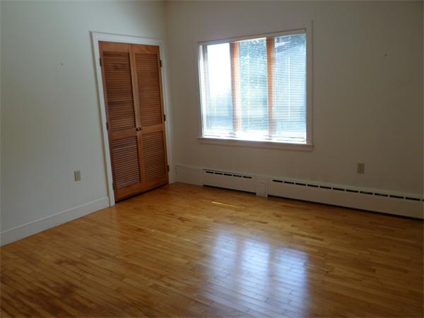 392 Point Road Marion, MA 02738 - Photo 14 of 21 an empty room with wooden floor and windows