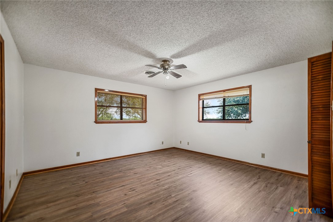181 Pecan Street Port Lavaca, TX 77979 - Photo 16 of 34 a view of a room with wooden floor and white walls