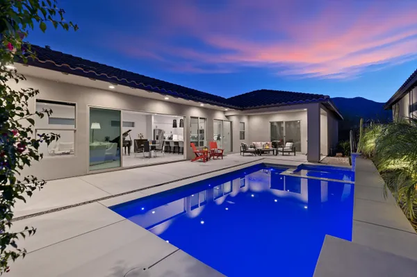 a view of swimming pool with outdoor seating
