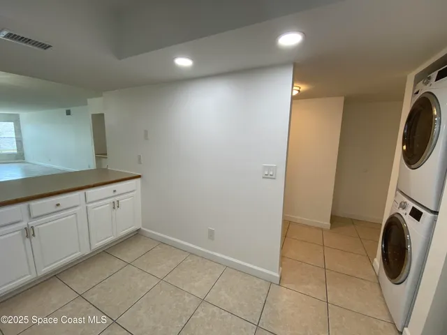 a utility room with sink dryer and washer