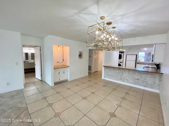 a view of a hallway with chandelier