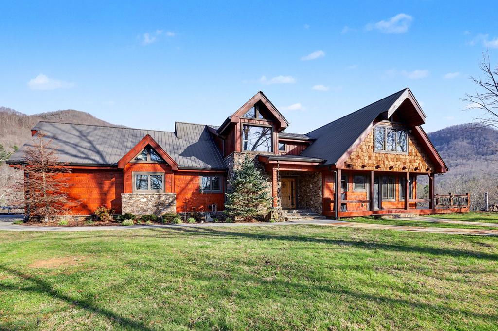 a front view of house with yard and outdoor seating