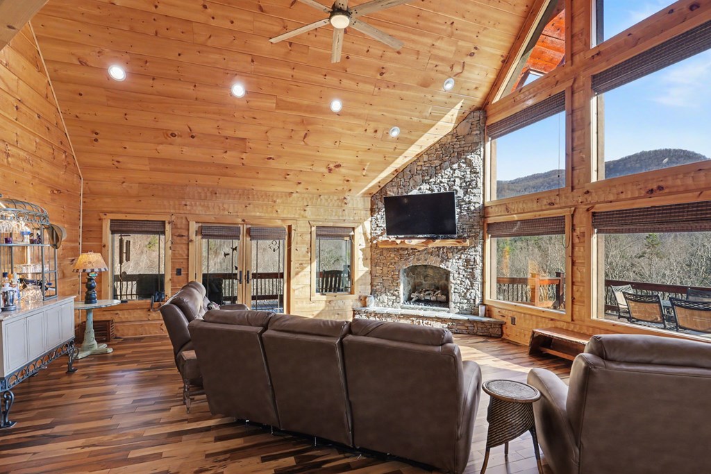 4760 Anderson Road Hiawassee, GA 30546 - Photo 14 of 104 a living room with furniture a fireplace and a flat screen tv