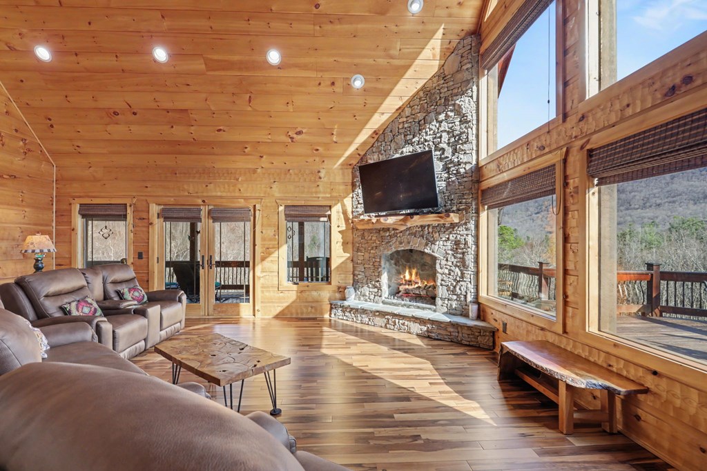 4760 Anderson Road Hiawassee, GA 30546 - Photo 15 of 104 a living room with fireplace furniture and a flat screen tv