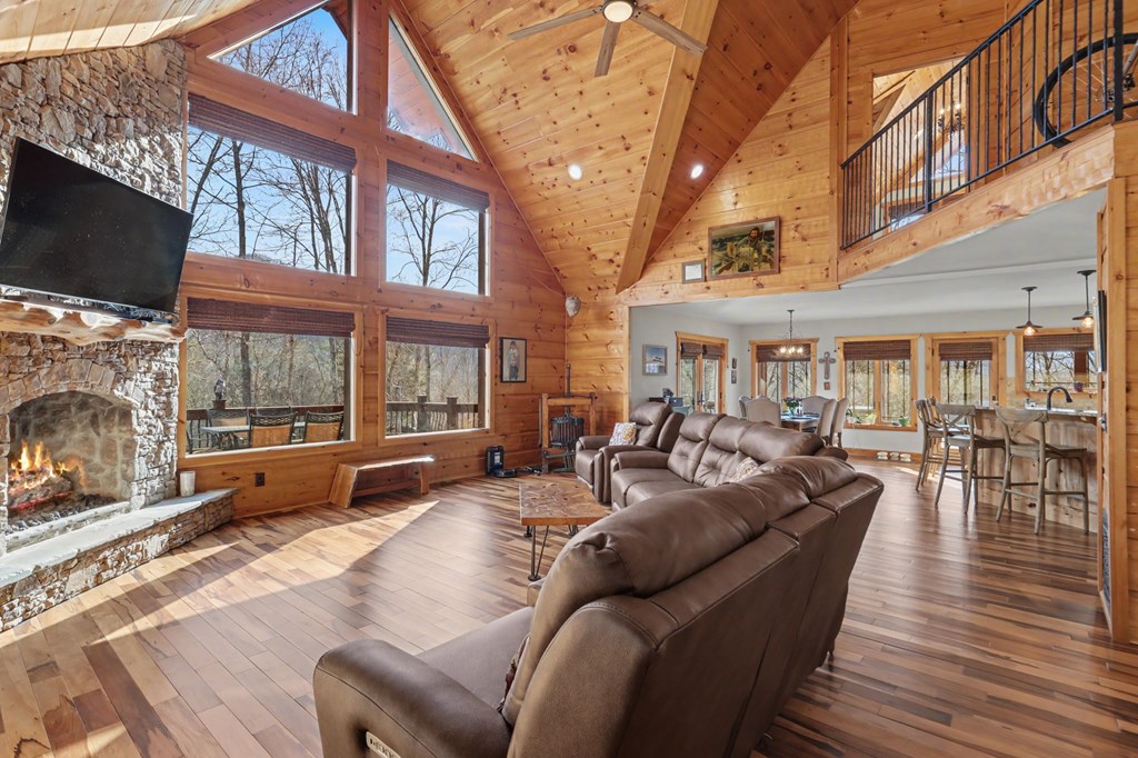 4760 Anderson Road Hiawassee, GA 30546 - Photo 17 of 104 a living room with furniture a flat screen tv and a fireplace
