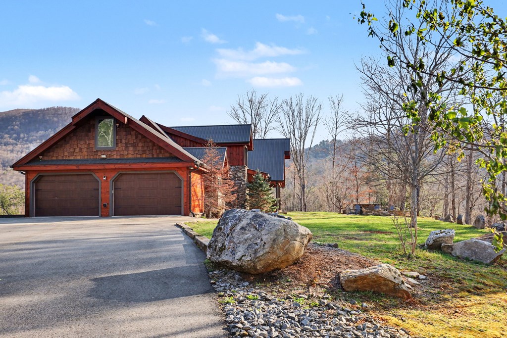 4760 Anderson Road Hiawassee, GA 30546 - Photo 2 of 104 a front view of a house with garden