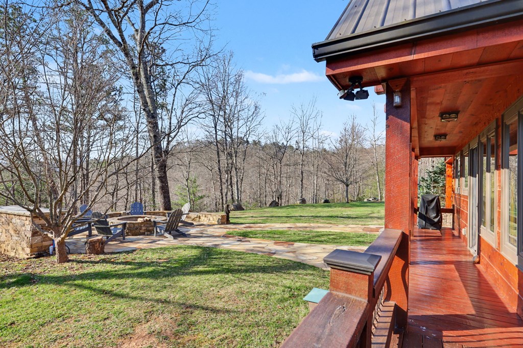 4760 Anderson Road Hiawassee, GA 30546 - Photo 27 of 104 a backyard of a house with barbeque oven table and chairs