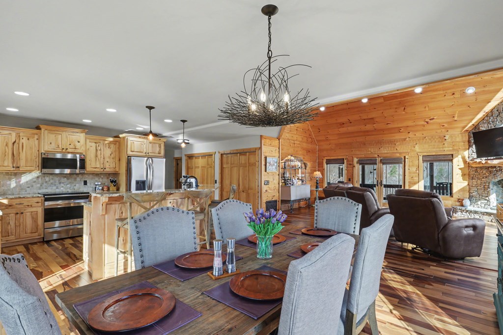4760 Anderson Road Hiawassee, GA 30546 - Photo 29 of 104 a view of a dining room with furniture a kitchen and chandelier