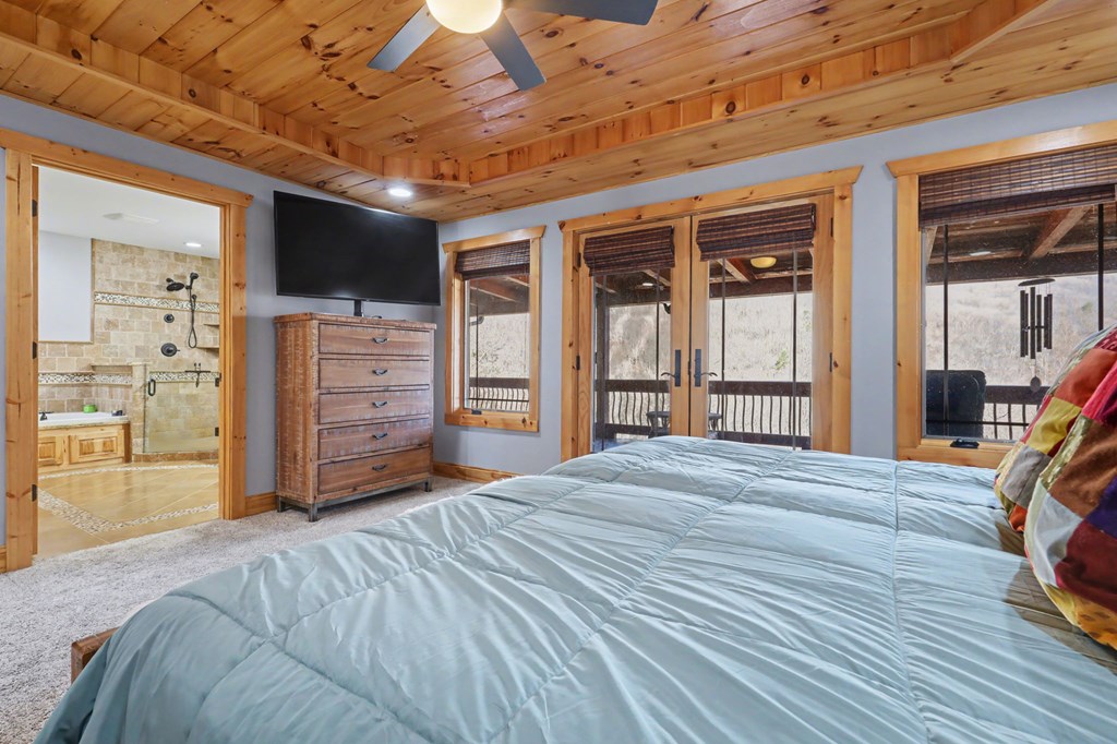 4760 Anderson Road Hiawassee, GA 30546 - Photo 34 of 104 a spacious bedroom with a bed and a flat tv screen