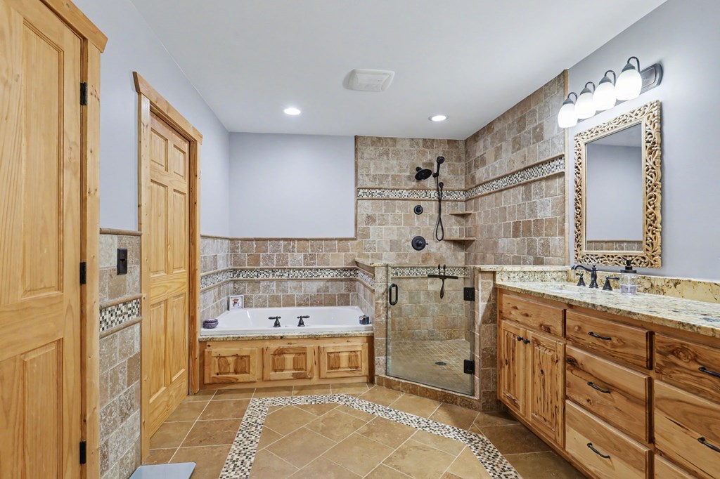 4760 Anderson Road Hiawassee, GA 30546 - Photo 36 of 104 a bathroom with a double vanity sink mirror and shower