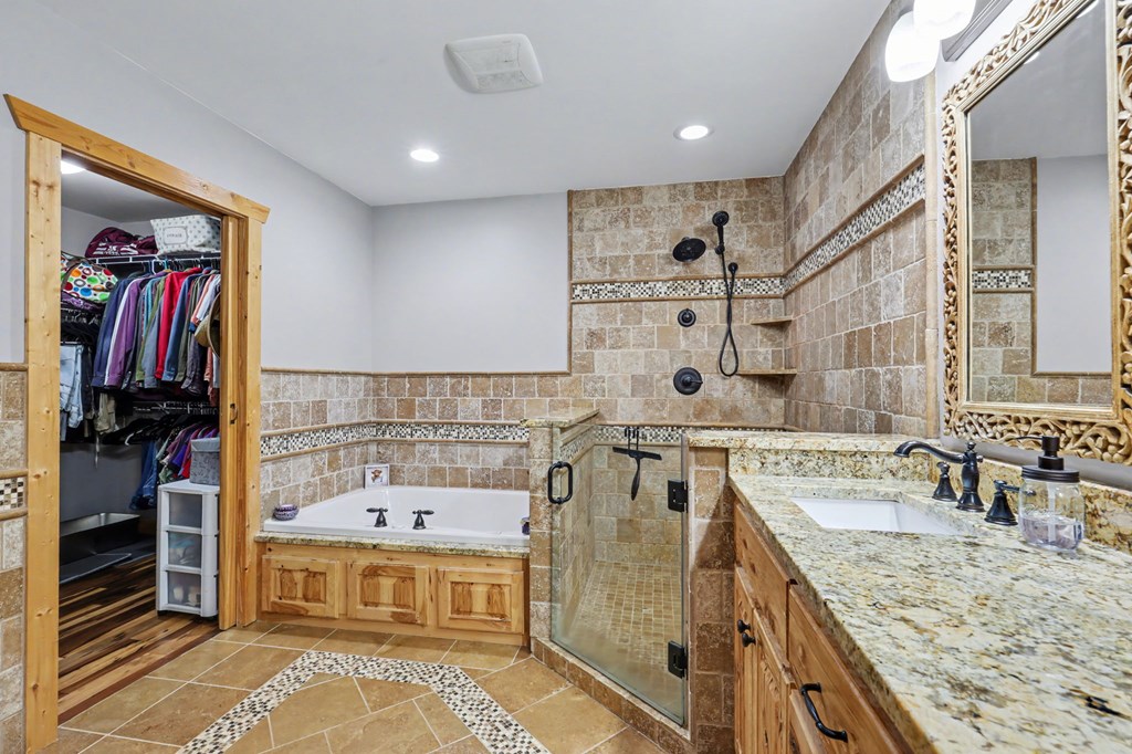 4760 Anderson Road Hiawassee, GA 30546 - Photo 38 of 104 a spacious bathroom with a granite countertop sink and a mirror