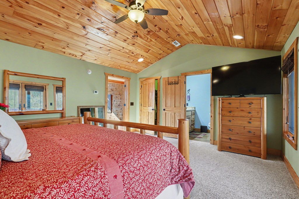 4760 Anderson Road Hiawassee, GA 30546 - Photo 53 of 104 a bedroom with a bed closet and flat tv screen