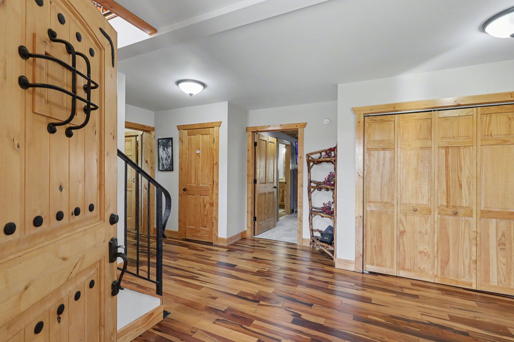 4760 Anderson Road Hiawassee, GA 30546 - Photo 7 of 104 a view of a hallway with wooden floor and staircase