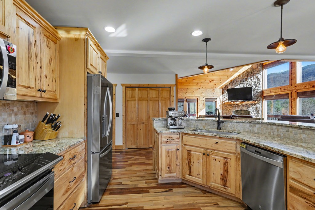 4760 Anderson Road Hiawassee, GA 30546 - Photo 10 of 104 a kitchen with stainless steel appliances granite countertop a sink stove and refrigerator