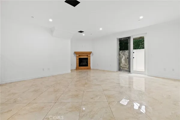 an empty room with closet and mirrors