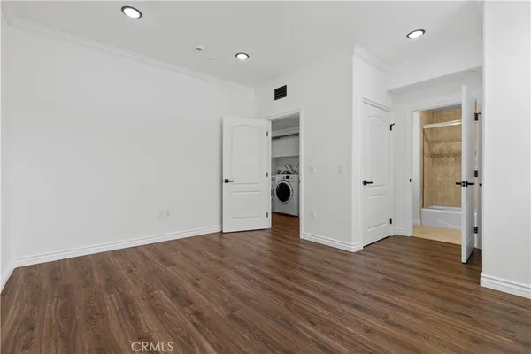 a view of walk in closet with empty racks