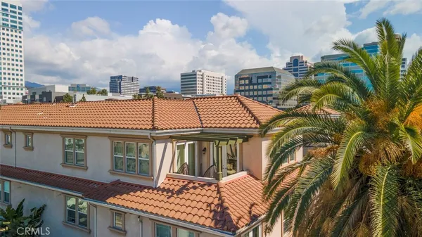 a front view of a house with a tree