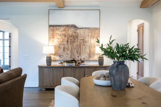 a kitchen with stainless steel appliances a sink wooden floor cabinets and a window