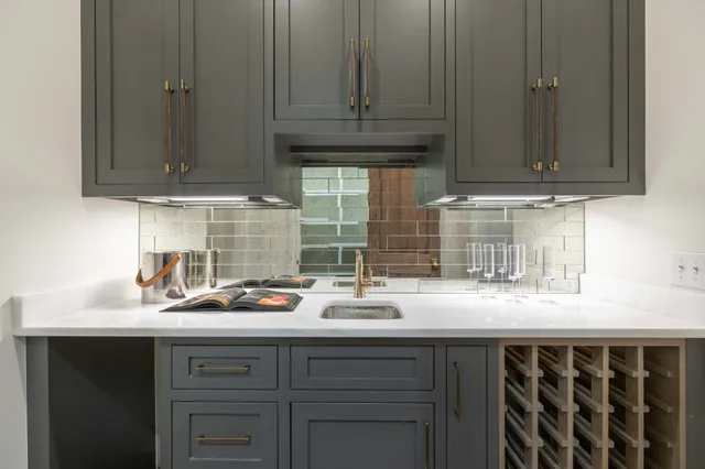 a view of a hallway with wooden floor and a bathroom