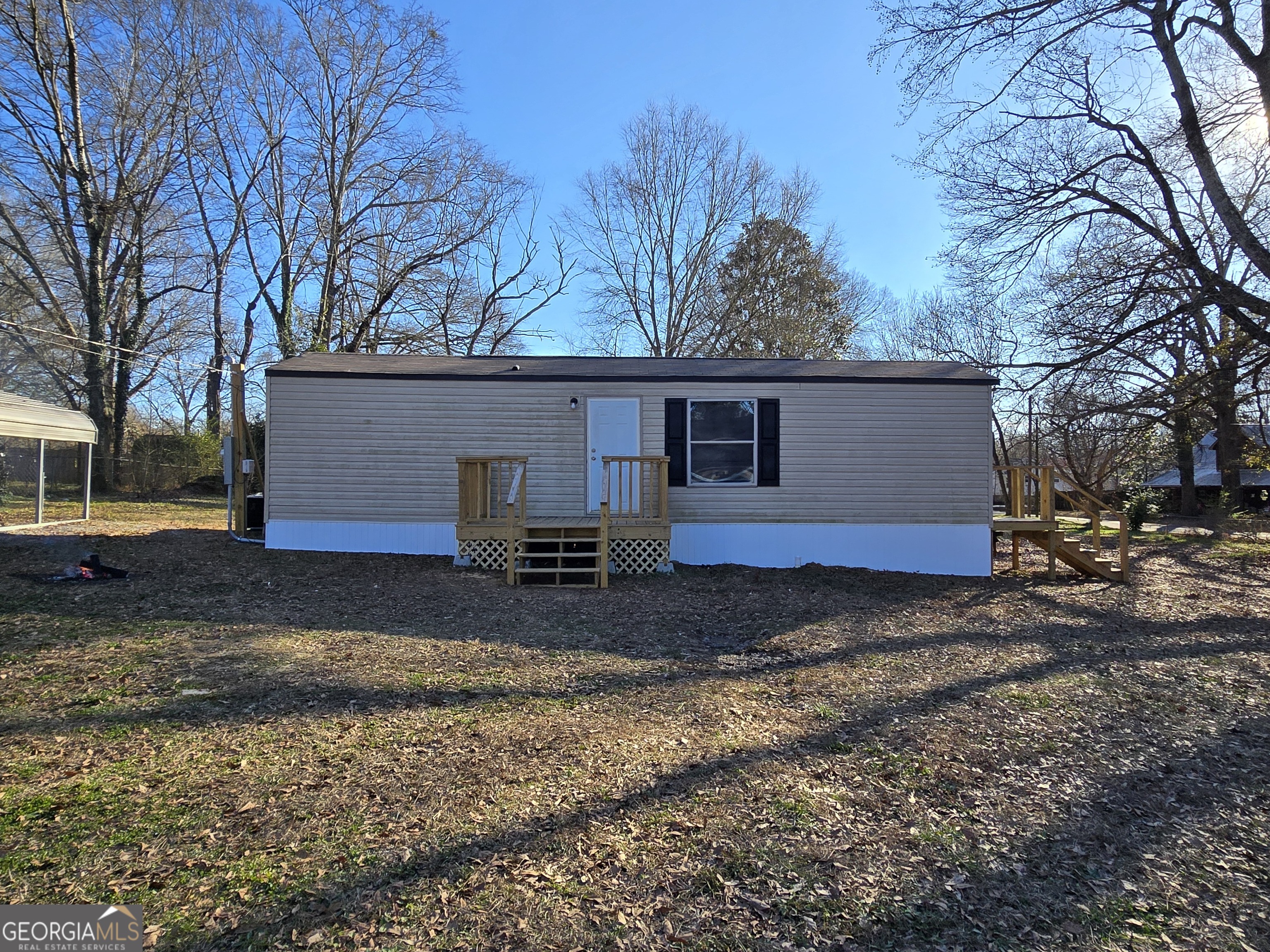 a view of a house with a yard covered with snow