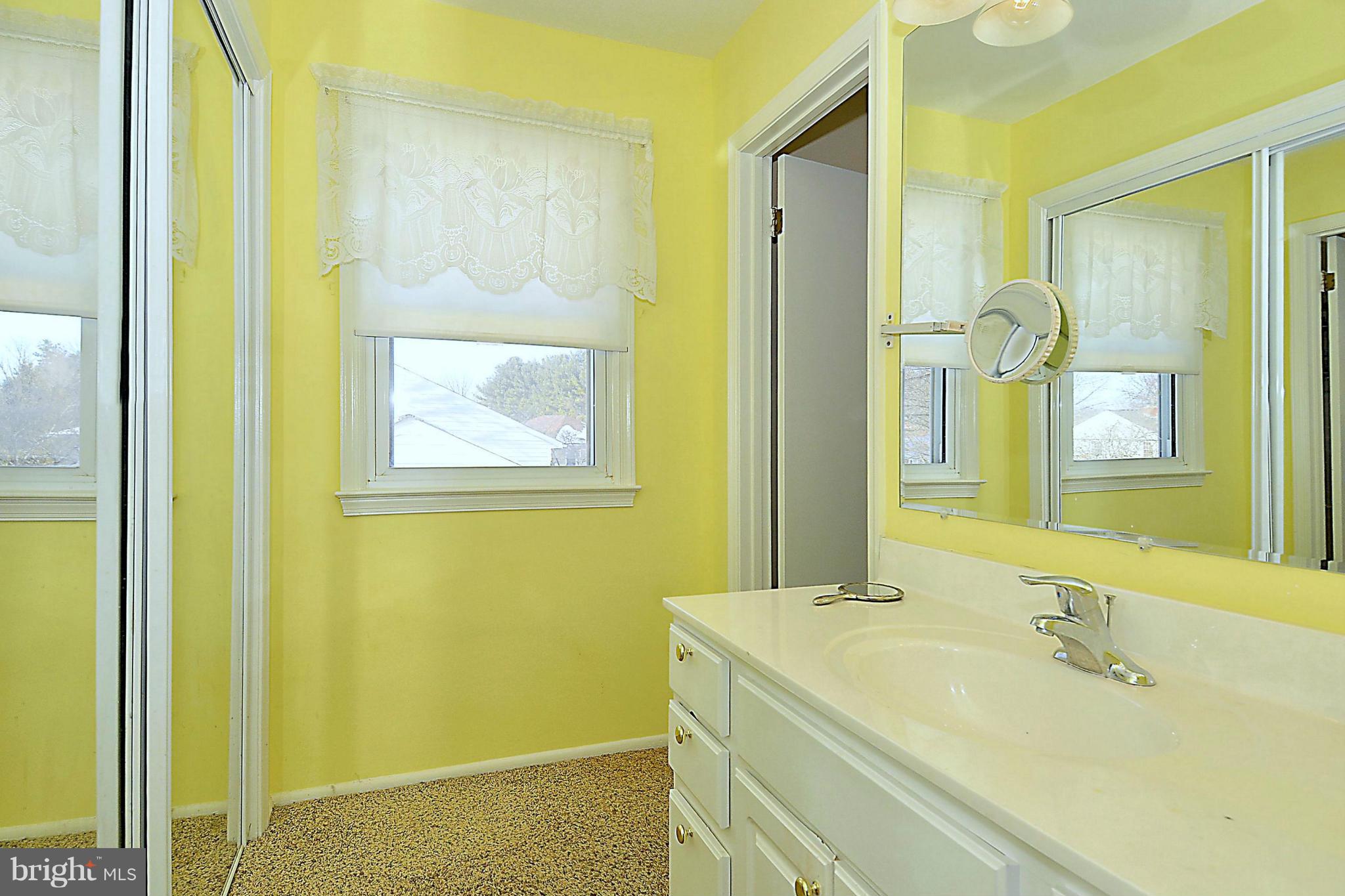 18731 Bloomfield Road Olney, MD 20832 - Photo 14 of 30 a bathroom with a tub sink and mirror