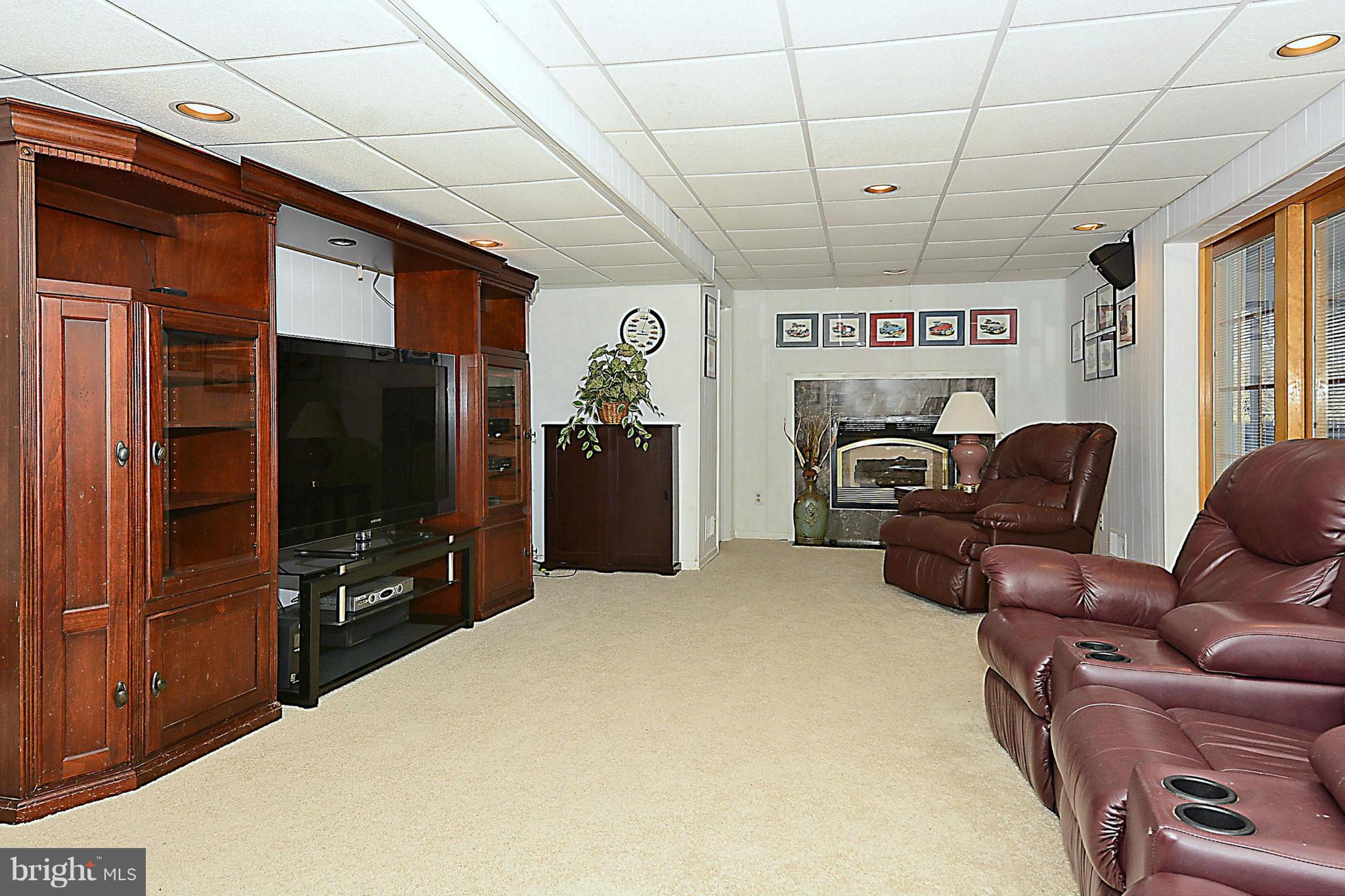 18731 Bloomfield Road Olney, MD 20832 - Photo 22 of 30 a living room with furniture and a flat screen tv