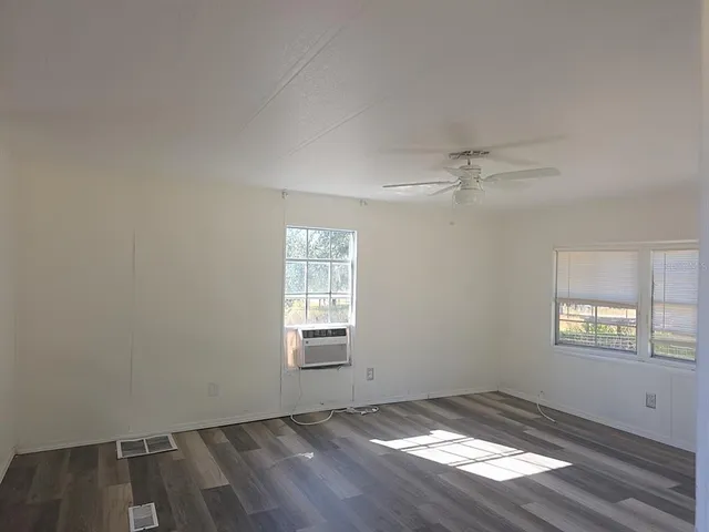 a kitchen with cabinets stainless steel appliances and a window