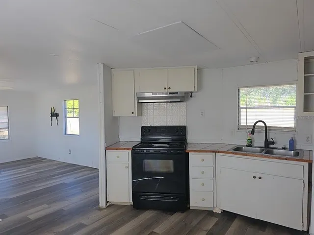 a kitchen with a sink dishwasher and a refrigerator