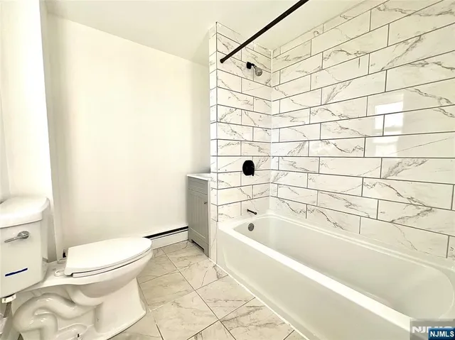 a bathroom with a toilet and a bathtub