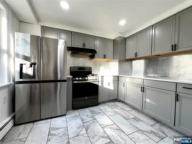 a kitchen with a refrigerator and a sink