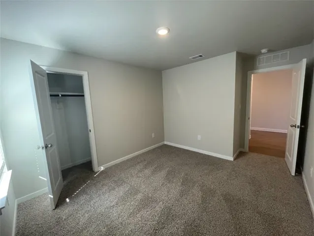 a kitchen with a sink cabinets and wooden floor