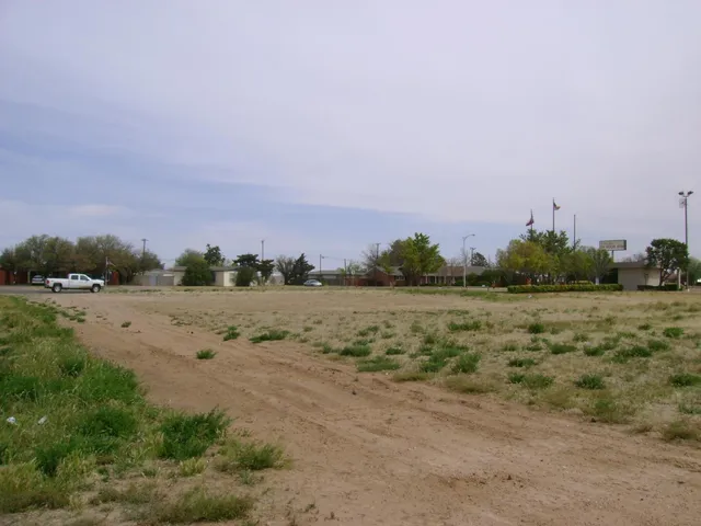 a view of a field with ocean view