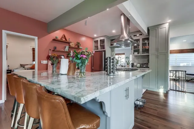 a kitchen with stainless steel appliances granite countertop a stove a refrigerator and a sink