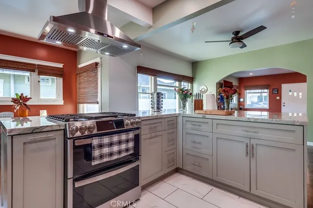a living room with furniture gym equipment and a large window