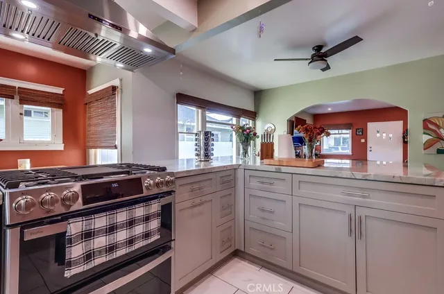 a living room with furniture hardwood floor and a potted plant