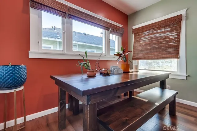 a bathroom with a toilet a sink and wooden floor